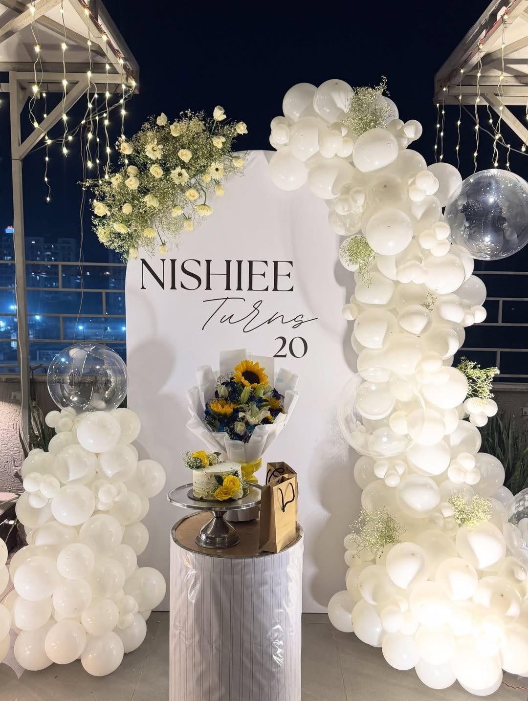 Elegant White Balloon Birthday Setup with Custom Name Backdrop